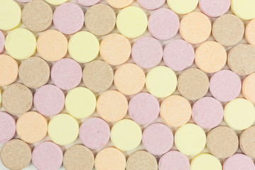 background of sweet sugar candy tablets with popping candy
