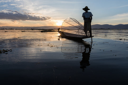 Traditional Burmese fisherman at Inle lake, Myanmar famous for their distinctive one legged rowing style