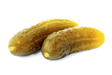 Pickled cucumbers isolated on a white background. Two pickled cucumbers isolated on a white background. Pickled cucumbers isolated. Crispy pickled cucumbers. 