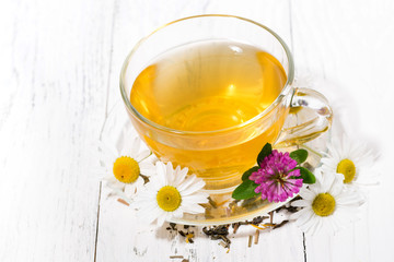 cup of fresh fragrant herbal tea on white background