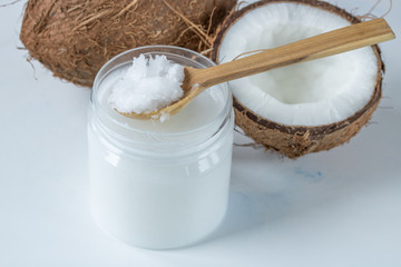 Coconut oil in a jar on the table on a white background