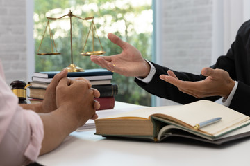 Concepts of law, Lawyer and businessman discussing contract and business papers.