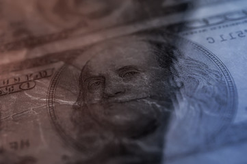 Closeup Benjamin Franklin on the 100 dollar grunge art abstract background. Dark, gloomy, crumpled.
