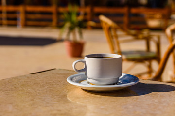 Cup of coffee on a table in street cafe