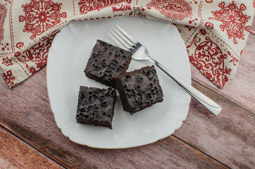Sliced homemade brownies on white plate. Served on rectangle white plate. Favorite chocolate...