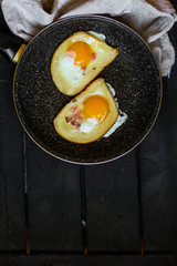 fried eggs in bread, scrambled eggs (yolk and white) sandwich. food background