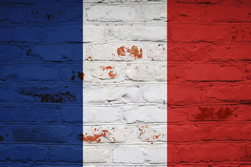 French flag on brick wall background. Background wallpaper for installation and design. Space for...