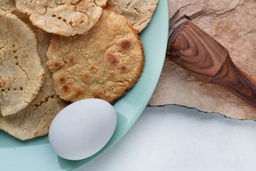 corn tortilla with boiled egg and coriander on stone background top view