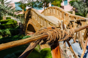 Vintage handrail made of the logs and hemp ropes