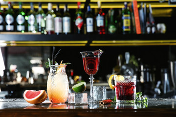 Fresh alcoholic cocktails in glasses on bar counter