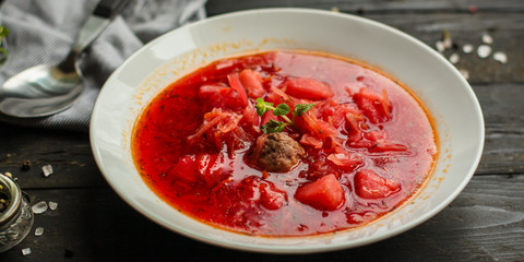 red tomato soup with vegetables and meat balls (borsch with meat) first course. top  food background. copy space