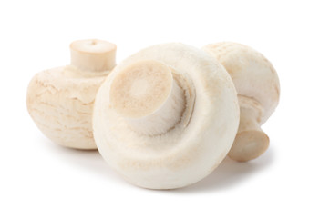 Fresh raw champignon mushrooms on white background