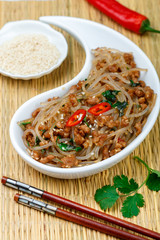 Chinese dish of starch glass noodles (rice, potatoes, beans) with meat (pork or beef), soy sauce, ginger, sesame, cilantro, red pepper. Cold or hot salad. stir-fry. Chapche. Eastern Asian cuisine