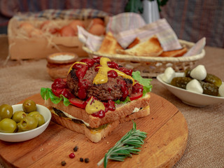 Toast with beef Patty, cucumbers, tomatoes and olives.