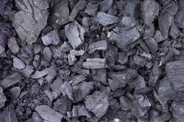 The texture of the cooled charcoal after the barbecue. Burnt charcoal without ash