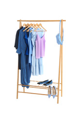 New wardrobe rack with stylish lady's clothes and shoes on white background