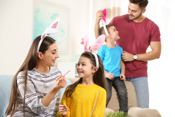 Happy family preparing for Easter holiday at home