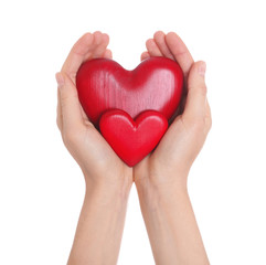 Woman holding decorative hearts in hands on white background, closeup
