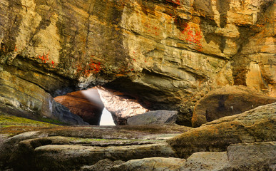 Arch rocks along the pacific coast with rays of sunshine