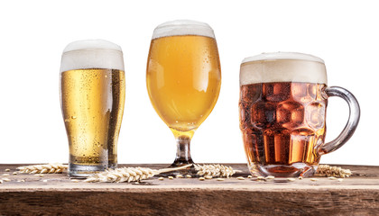 Three different glasses of beer on wooden table. Clipping path.