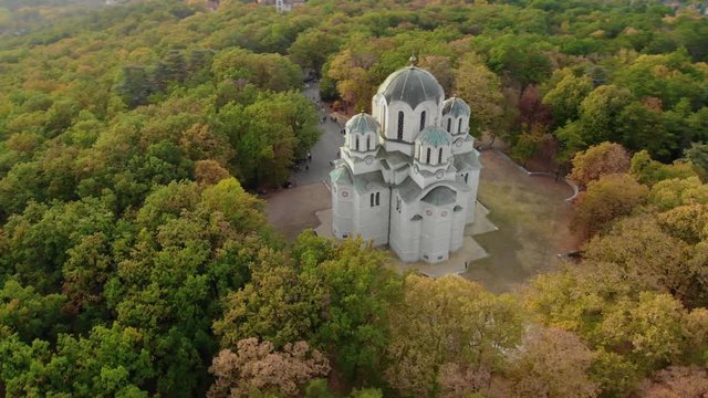 Church in the woods on top of a hill Aerial footage of St George's Church also known as Oplenac church, which is the mausoleum of the Serbian and Yugoslav royal house of Karađorđević located on top of