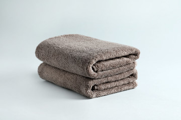 Stack of fresh fluffy towels on grey background