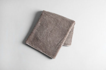 Fresh fluffy towel on grey background, top view. Mockup for design