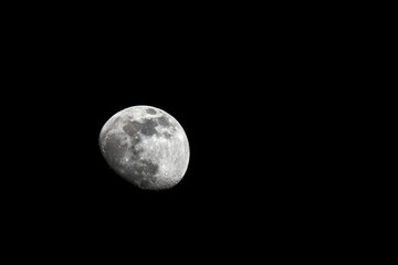 Detailed photo of the moon (waxing gibbous phase) with craters visible.