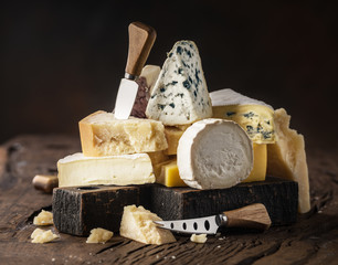 Fototapeta Assortment of different cheese types on wooden background. Cheese background. obraz