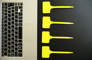 Laptop Keyboard and Empty Yellow Labels isolated on Black Background © imagestock