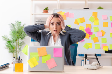 Young female employee in conflicting priorities concept 