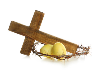 Wooden cross, crown of thorns and Easter eggs on white background