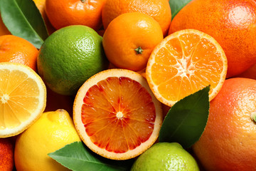 Different citrus fruits as background, top view