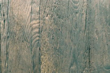 Background of green stone with a wood grain texture. The relief texture of the stone is rough. Rectangular photo.