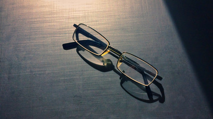 glasses on a dark background, shadow of the rim, metallic material