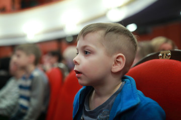 Surprised boy in theater