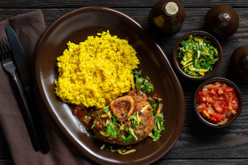Braised veal shank, ossobuco, served with risotto and gremolata.