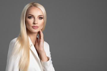 Beauty blonde girl in white jacket