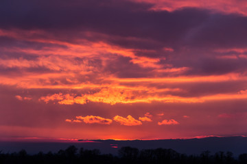 Dark orange unset over the Vosges watched from Germany