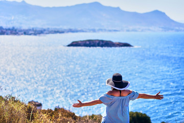 Beautiful woman in beach hat enjoying sea view with blue sky at sunny day in Bodrum, Turkey. Vacation Outdoors Seascape Summer Travel Concept