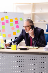 Aged man employee in conflicting priorities concept 