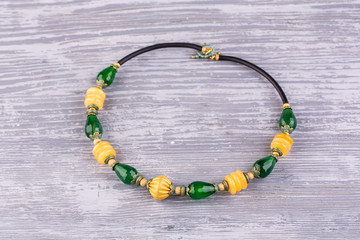 A necklace from green chalcedony with inserts from onyx with a vintage bead