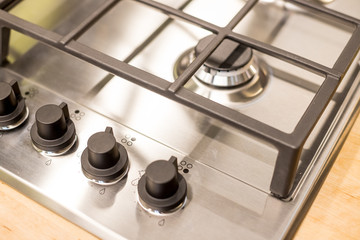 Metal gas stove on modern kitchen. the concept of forced savings on utilities Gas stove.knob heat...