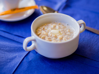 oatmeal on a blue background with orange juice and coffee