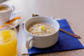 oatmeal on a blue background with orange juice and coffee