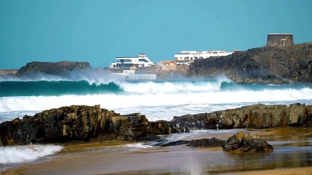 El Cotillo, beach with breaking of waves, view to the tower, Fuerteventura