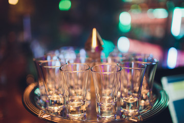 Empty shot glasses on bar counter selective focus.