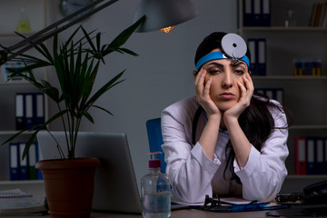 Young female doctor working at night shift 