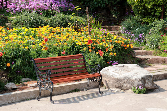 Garden bench in the park flower colorful image background.