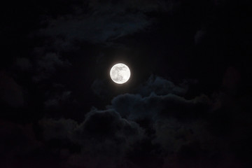 Moon through the clouds at night, super moon
